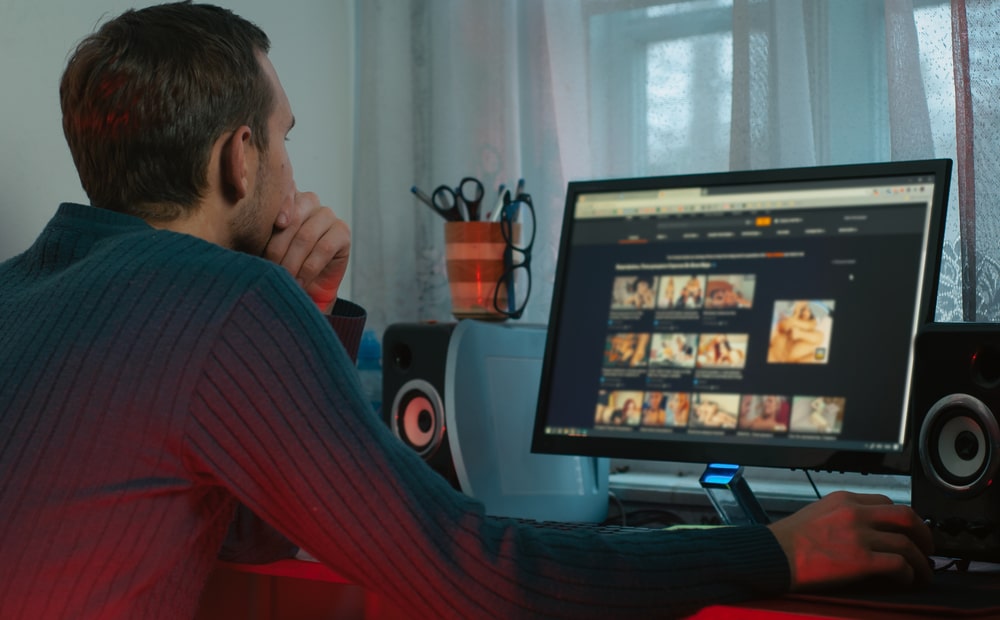 man watching adult content on his computer